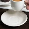 Acopa 4 7/8" Ivory (American White) Rolled Edge Stoneware Saucer - 6/Pack