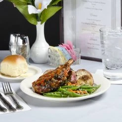 Acopa 9 5/8" Ivory (American White) Wide Rim Rolled Edge Stoneware Plate - 12/Pack