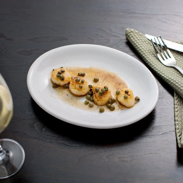 Acopa 9 3/4" X 7 1/2" Bright White Oval Coupe Stoneware Platter - 24/Case 1 Acopa 9 3/4" X 7 1/2" Bright White Oval Coupe Stoneware Platter - 24/Case