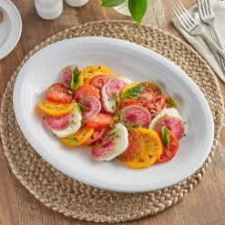 Acopa Capri 13 3/4" X 10 1/2" Coconut White Oval Stoneware Coupe Platter - 12/Case