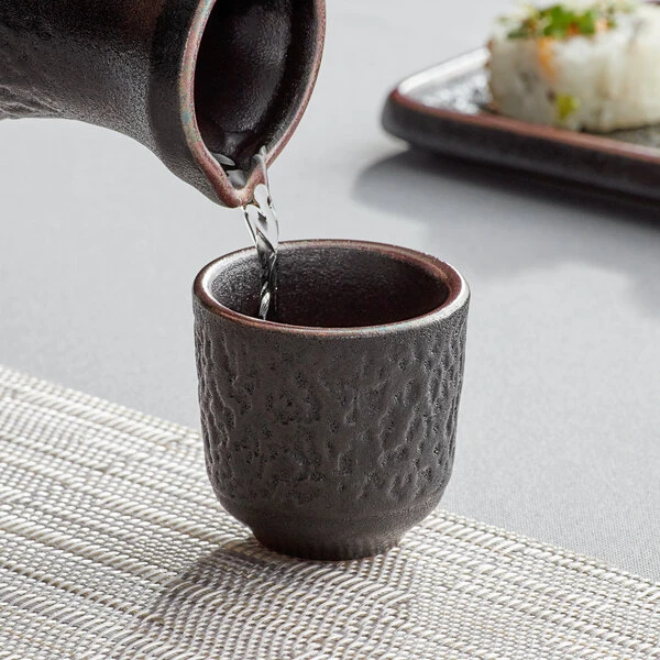 Acopa Heika 1.5 Oz. Black Matte Textured Stoneware Sake Cup - 24/Case 1 Acopa Heika 1.5 Oz. Black Matte Textured Stoneware Sake Cup - 24/Case