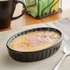 Acopa 6 Oz. Oval Glossy Black Fluted Stoneware Souffle / Creme Brulee Dish - 12/Pack