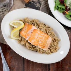 Acopa 9 3/8" X 6 1/2" Ivory (American White) Wide Rim Rolled Edge Oval Stoneware Platter - 24/Case